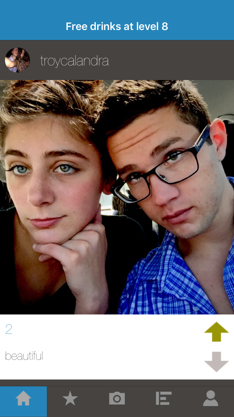 A screenshot of Fraze Frame's home feed. It contains a photo of two people sitting in a car along with up/down vote buttons to vote on the post.